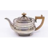 A George V silver tea pot, with angular fruitwood handle and finial, ball feet, hallmarked London,