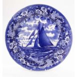 A blue and white charger by Wedgwood, decorated with a floral band of passion flowers and a main