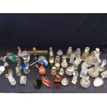 A collection of mixed glass perfume bottles, boxes, lighter and fish shaped vase, to include a