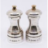 An Elizabeth II silver salt & pepper grinder, hallmarked by M C Hersey & Co. (2)