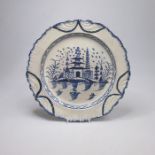 A Liverpool pearlware blue and white plate, with a chinoiserie scene, bordered with feathered leaf