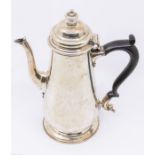 A Victorian plain silver coffee pot, engraved with a monogram, ebony handle, hallmarked by James &