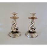 A pair of Italian sterling silver candlesticks, having stylised dolphin stems, height 16cm. (gross