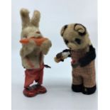 Two Automaton toys, c.1940's, to include a panda bear pouring and drinking milk and a rabbit