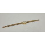 An 18ct. gold Longines ladies' bracelet watch, manual movement, cal.410, having signed silvered