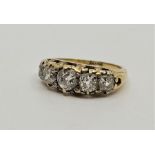 A late 19th century 18ct. gold five stone diamond ring, prong set five graduated old-cut diamonds