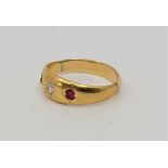 A precious yellow metal, diamond and ruby ring, gypsy set old-cut diamond to centre and mixed oval