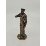 A 20th century brass figure of a Royal Navy Boatswain, standing and blowing Bosun's whistle,