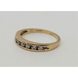 A 9ct. yellow gold seven stone diamond ring, channel set seven round brilliant cut diamonds (ETDW