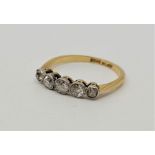 An Edwardian 18ct. gold and platinum five stone diamond ring, set five graduated old-cut diamonds (