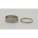 An 18ct. white gold textured band, London 1971, size UK O 1/2 (4.7g), together with a platinum