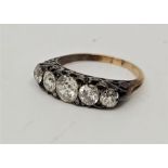 A Victorian precious yellow metal five stone diamond ring, set five graduated old-cut diamonds