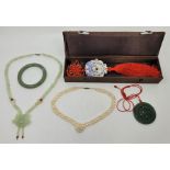 A celadon green jade pendant necklace, length 54cm, in box, together with a green jade bangle,