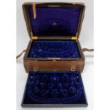 A Victorian bespoke leather and brass bound jewellery case, blue velvet lined with three trays