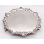 A George III silver salver, the raised border with shells and scrolls, the centre engraved with a