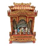 A Chinese carved, scarlet lacquer and gilt theatre stage with swept eves to the roof, decorative