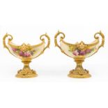 A matched pair of Royal Worcester blush ivory two handled pedestal bowls, boat shaped bodies painted