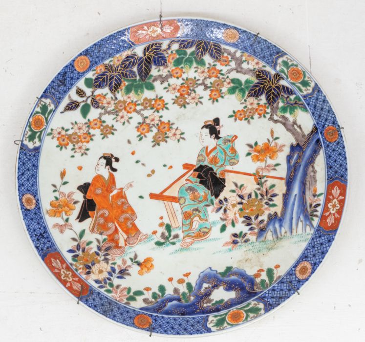 A late 19th Century Japanese Chinese Imari large charger, circa 1900, painted with two Geisha, one