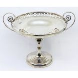 A large George V silver two handled tazza/comport, with swirl handle design, pierced border and on