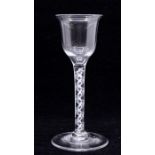 An 18th Century wine glass, ogee bowl with flared rim above white opaque air twist stem, conical