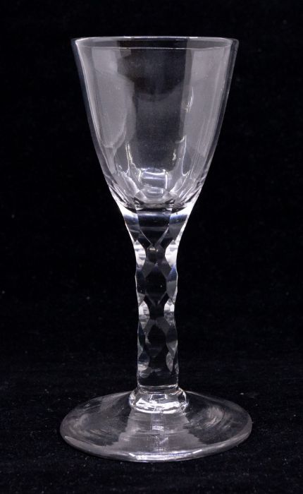 An 18th Century wine glass, the bowl with facet cut sections to lower bowl, facet cut stem, on