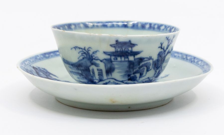 A Chinese Nanking Cargo blue and white tea bowl and saucer, painted with the Pagoda pattern. No