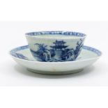 A Chinese Nanking Cargo blue and white tea bowl and saucer, painted with the Pagoda pattern. No