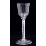 An 18th Century wine glass ogee, plain ogee bowl above white opaque air twist stem, stepped