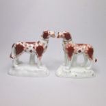 A pair of Staffordshire Red Setter dogs, standing on rocky mounds with gilt highlights Date circa