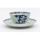 A Chinese Nanking Cargo blue and white tea bowl and saucer painted with Blue Pine pattern. With