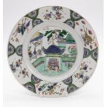 A Chinese famille verte porcelain plate, Kangxi (1662-1722), centrally painted with figures in