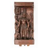 An Indian relief carved figure of Vishnu with two acolytes holding attributes and two elepephants,