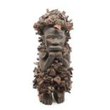 An African Kongo Kninsi wood fetish figure, embellished with nut shells, approx 39cm high