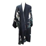 A Japanese kimono from the late 1930s, made of black satin decorated in ferns and butterflies with a