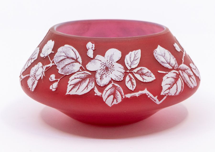 A Stourbridge style ruby cameo glass tapering case, decorated with rose hips, the base 12cm diam