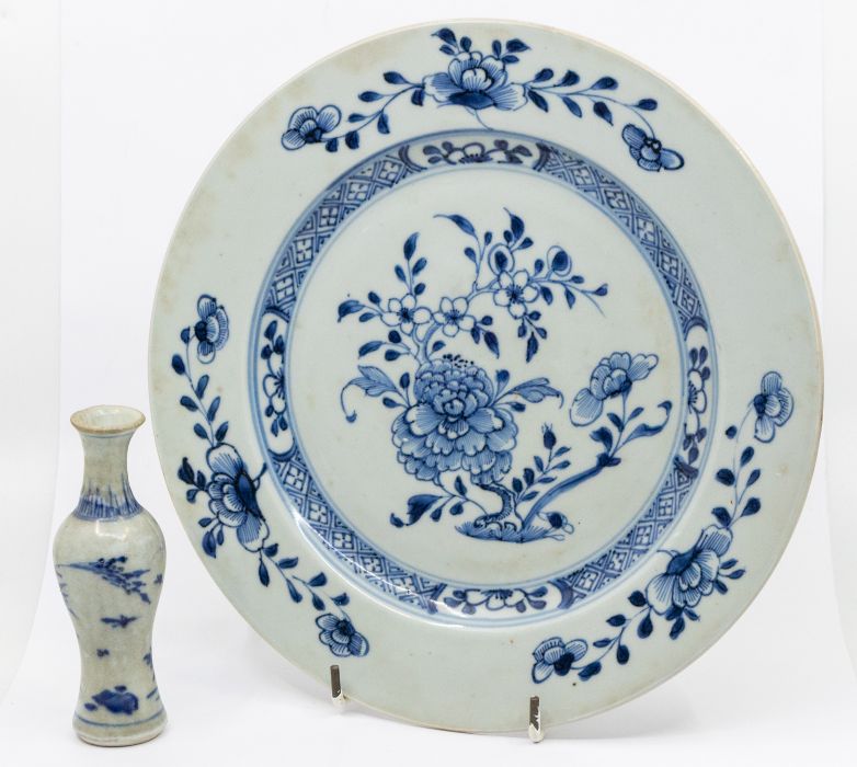 A Chinese Nanking blue and white plate, painted with flowering branches and a Peony. Harrods
