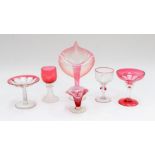 A collection of 19th & 20th Century ruby glass to include: lily leaf posy vase; wine glass with ogee