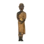 An Asian gilt metal figure of standing Buddha, 48cm high  Further details: damage to lower section