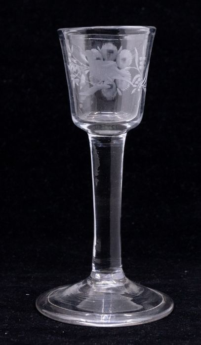 An 18th Century wine glass, the bowl engraved with a perched bird, a large flower and foliage, on - Image 2 of 4