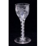 An 18th Century wine glass, the bowl engraved with a flying bird, grapes and vine leaves, on white