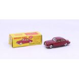 Dinky: A boxed Dinky Toys, Jaguar 3.4 Saloon, red body with lemon interior, Reference 195.