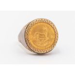 A 1982 1/10 Krugerrand, set in a yellow metal clip ring mount. Size M. Gross weight approximately