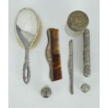 Seven pieces of antique silver mounted vanity ware including brushes, combs and lidded jars.