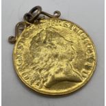 A George I gold guinea. In very rubbed condition and soldered onto a yellow metal mount. Gross