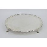 Tiffany & Co silver salver with piecrust rim and raised on four pad feet. Hallmarked London 1931