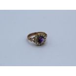 An amethyst and rose cut diamond set cluster ring in yellow metal mount. Size M. Gross weight