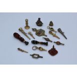 A collection of watch keys, to include yellow metal and pinchback/ base metal examples, some stone