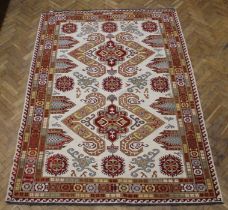 A Soumac flatweave rug having an ivory ground heightened in brown and red medallion, 265 x 184cm