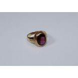 An 18ct gold ring, set oval garnet to beaded shoulders, 7gms gross weight, size S