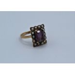 An Amethyst and seed pearl dress ring in 9ct yellow gold, size N. Gross weight approximately  4.0